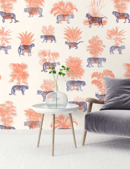 Living room with a wall featuring a pattern of leopards and plants, a table with a vase and plant, and a gray sofa.