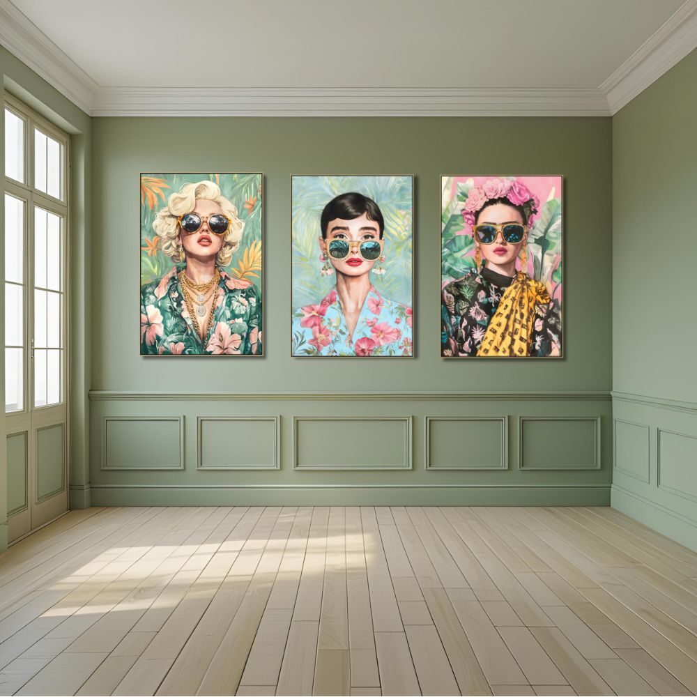 Three colorful portraits of women with sunglasses on a green wall.