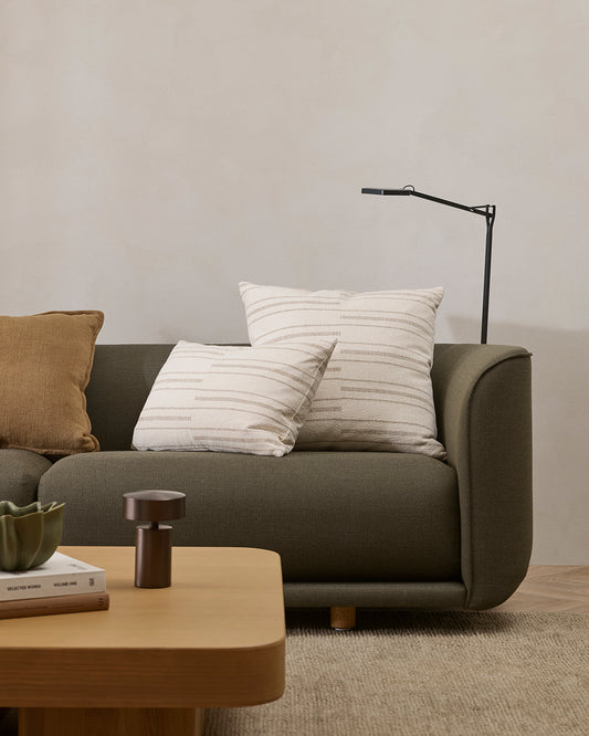Gray sofa with cushions in a living room setting