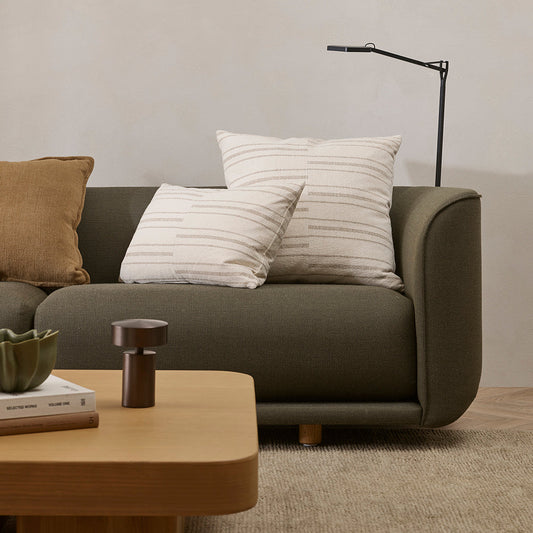 Gray sofa with cushions in a living room setting