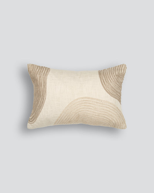 Decorative pillow with wavy embroider on a cream background