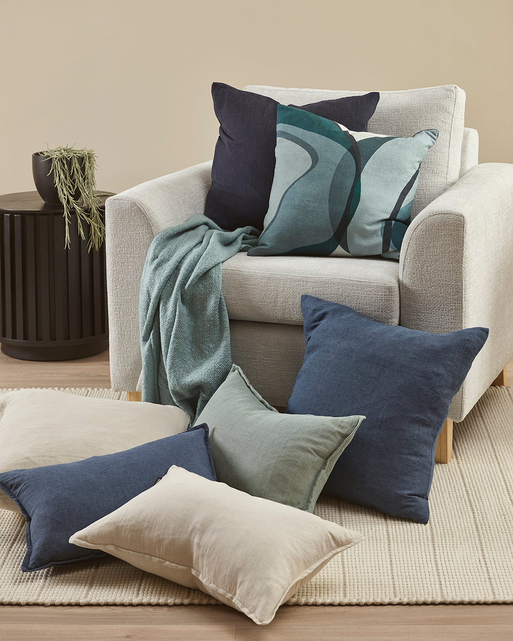 Decorative pillows on a sofa and floor in a living room setting