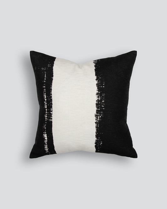 Black and white striped pillow on a light gray background