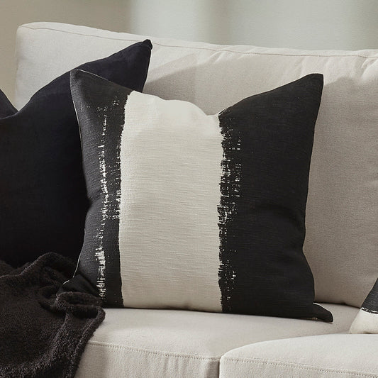 Black and white pillows on a beige sofa