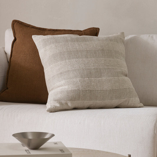 Decorative pillows on a sofa with a neutral color scheme