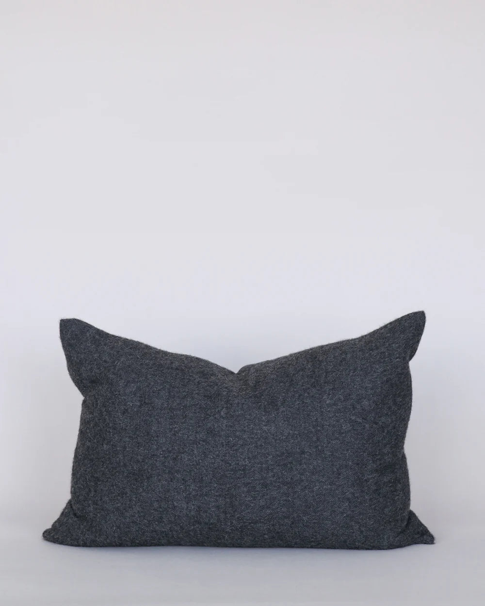 Dark gray pillow on a white background