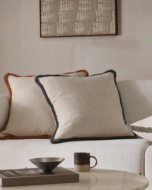Decorative pillows on a sofa with a coffee table in the foreground