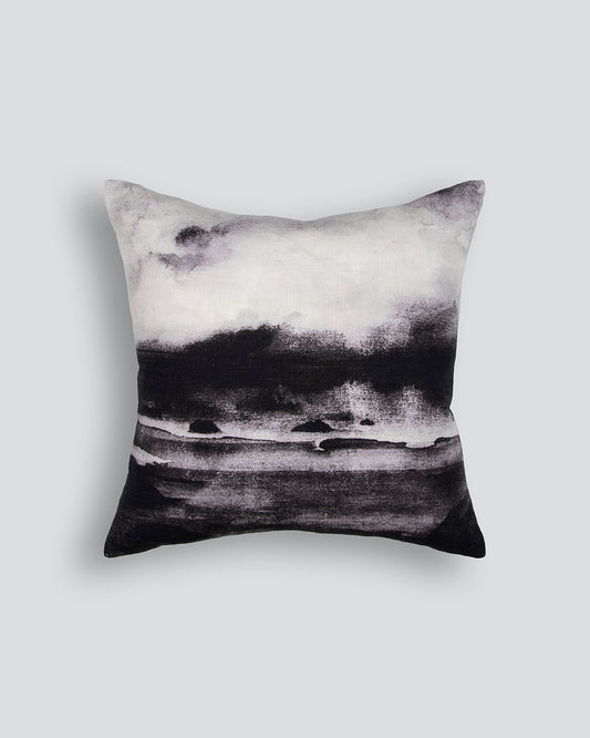 Decorative pillow with black and white abstract design on a light gray background