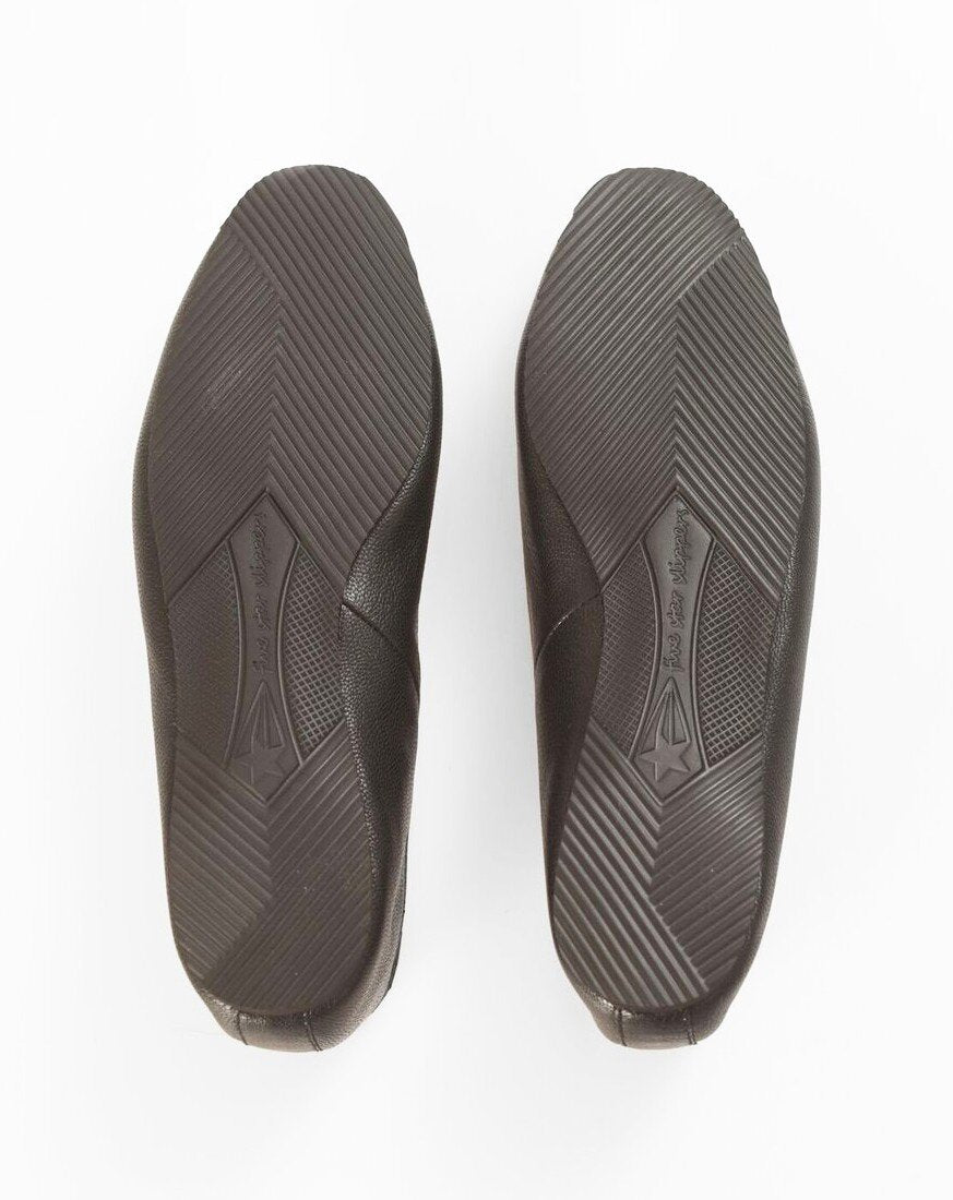 Top-down view of a pair of dark brown shoes showing the textured outsoles on a white background.
