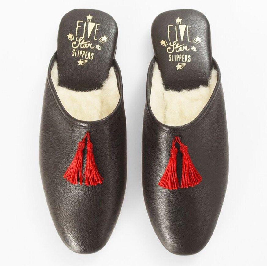 mule black leather slippers with a red tassel and wool lining