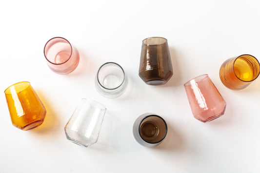 Set of colorful glass tumblers on a white background
