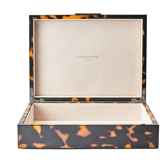 Tortoiseshell-patterned jewelry box with 'Addison Ross' branding on a white background