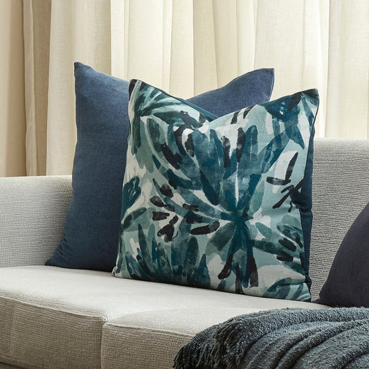 Decorative pillows on a couch with a neutral background
