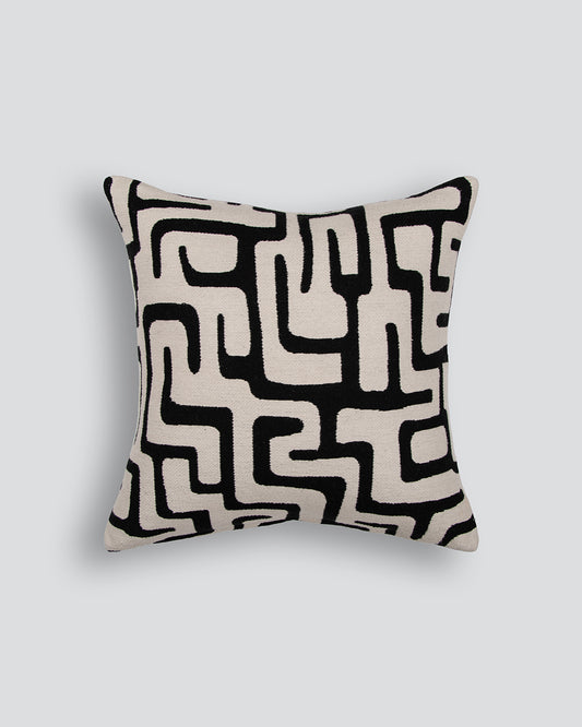 Decorative pillow with black geometric pattern on a white background