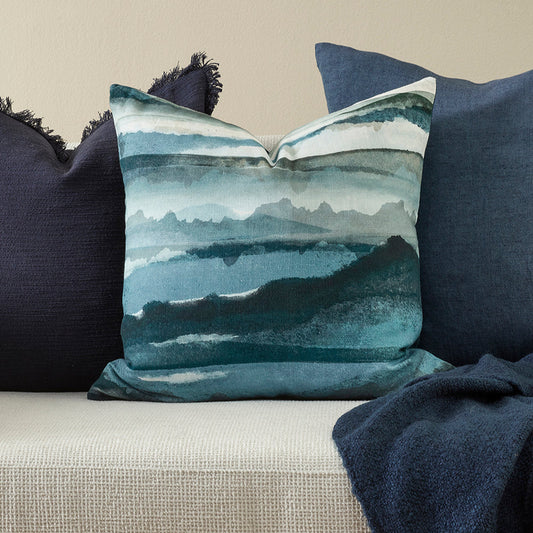 Decorative pillow with watercolor design on a couch