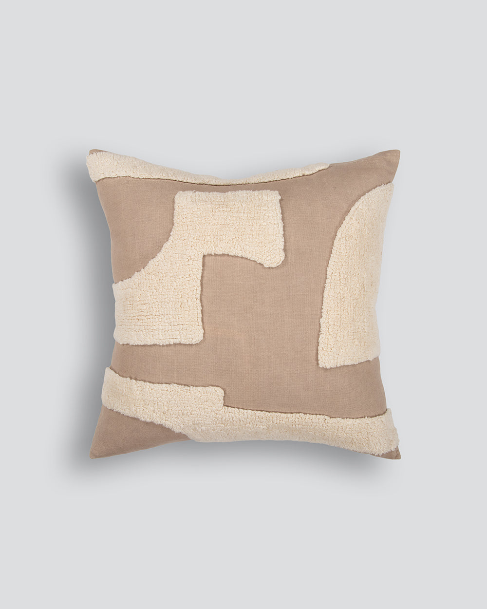 Decorative pillow with geometric pattern on a plain background