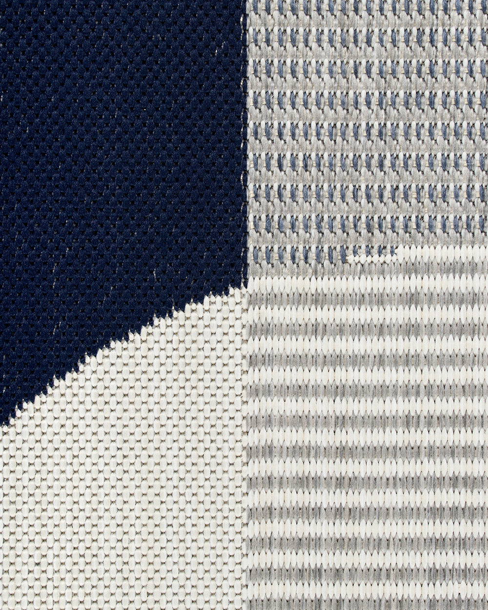 Close-up of fabric with a striped pattern transitioning from dark blue to white.