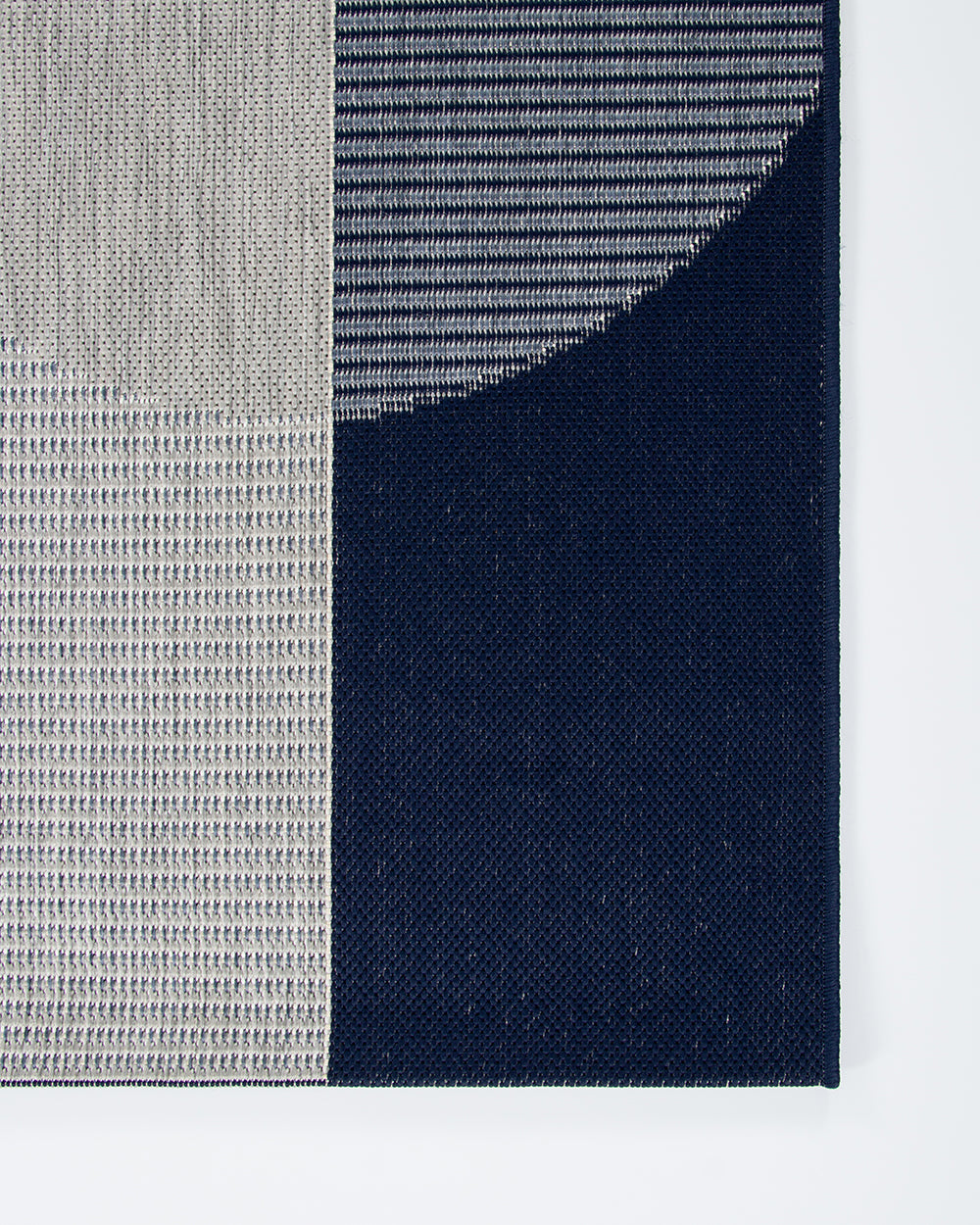 Textured fabric swatch in gray, blue, and navy on a white background
