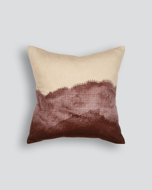 Beige and brown pillow on a light gray background