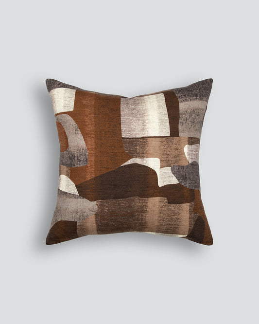 Decorative pillow with brown and beige abstract pattern on a light gray background