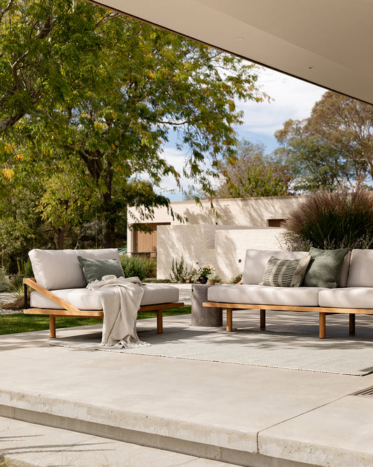 Outdoor patio with modern furniture and greenery