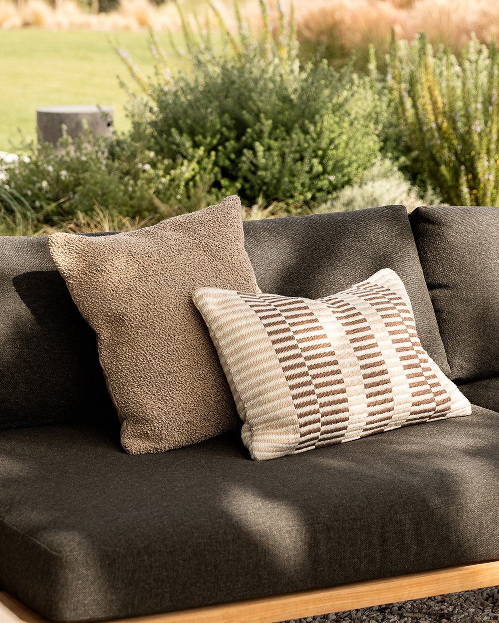 Brown sofa with patterned cushions in an outdoor setting