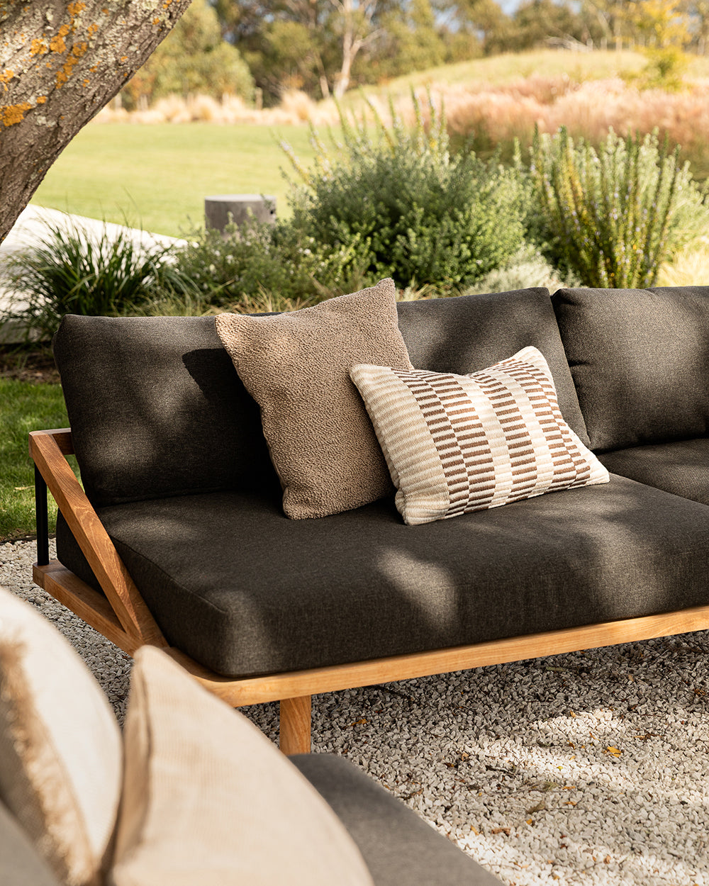 Outdoor sofa with cushions in a garden setting