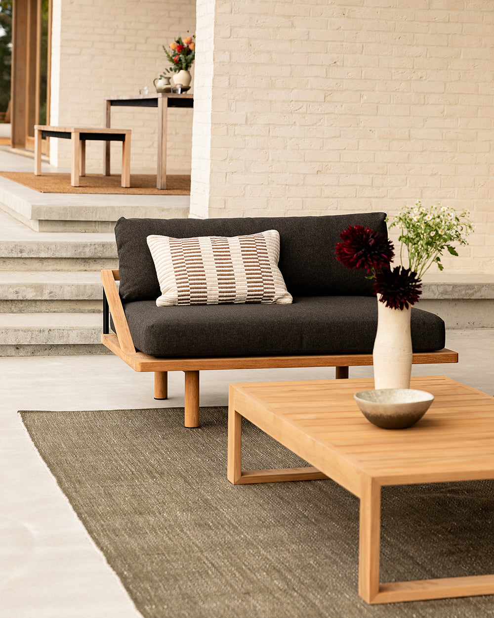 Outdoor furniture set with a sofa and coffee table on a patio.