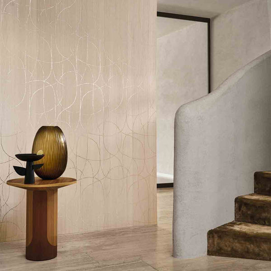 Decorative vase on a small table against a textured wall with a staircase in the background