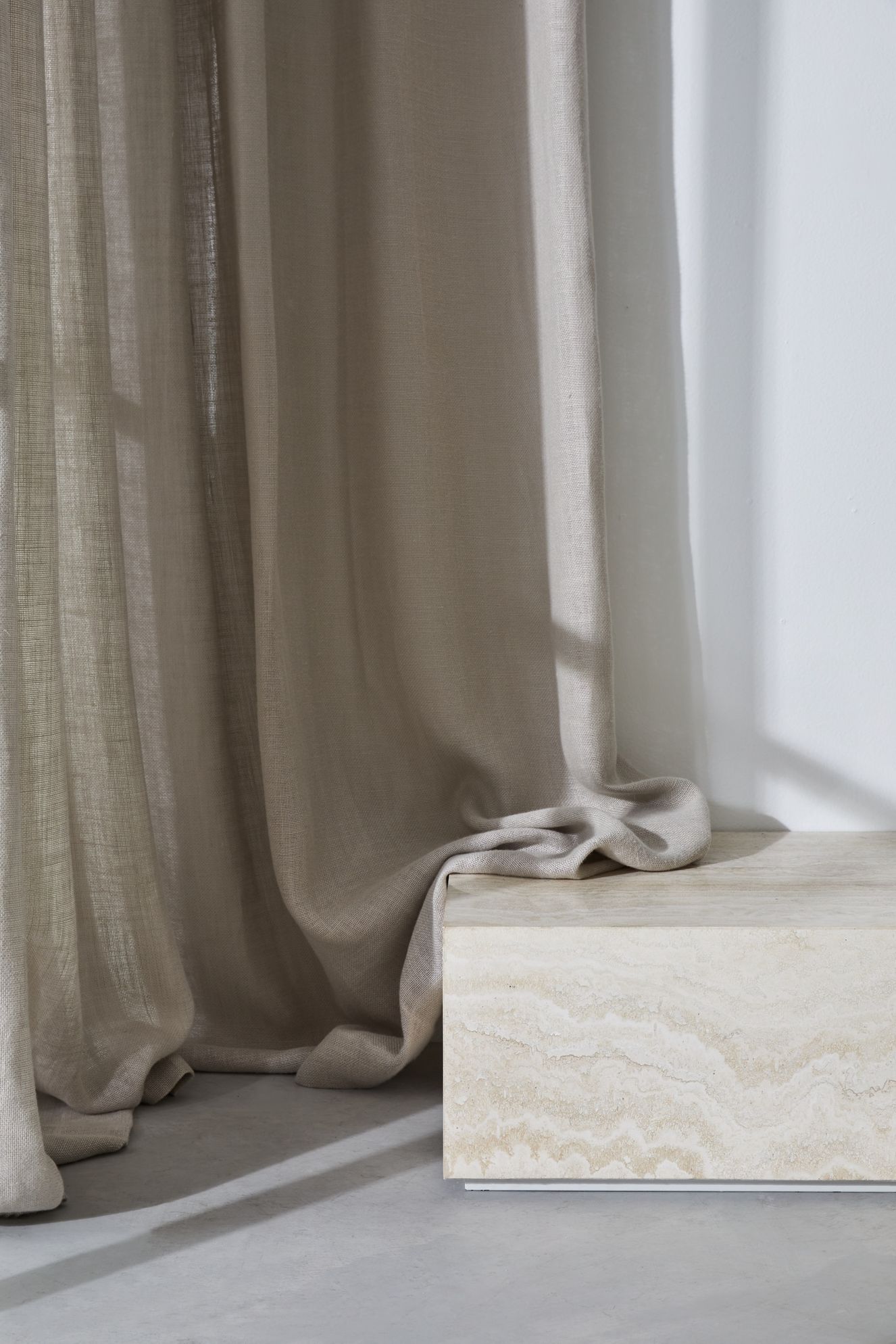 Boracay plain linen fabric draped on stone bench