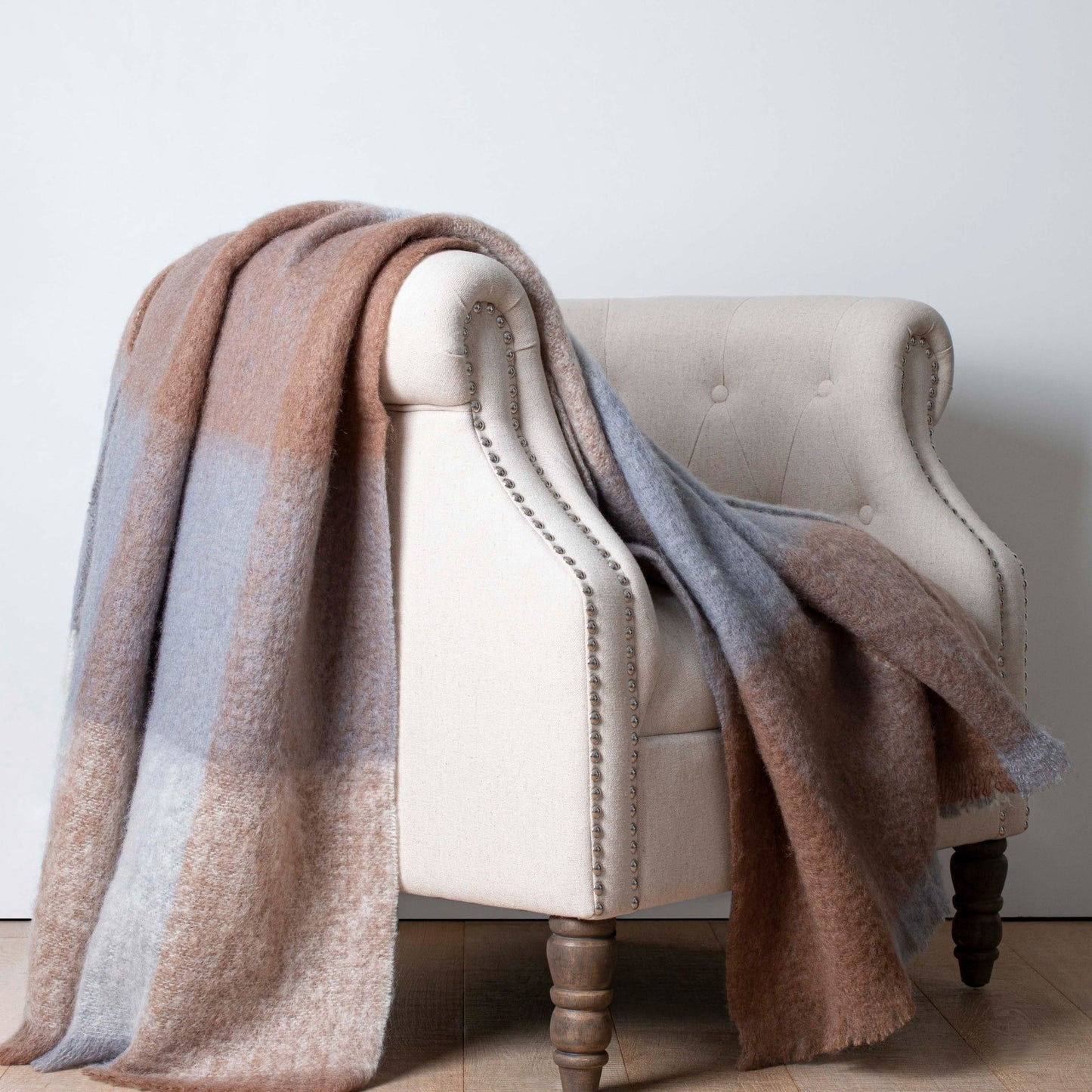 Soft Mohair luxury throws from Glamorous Goat. Mohair throw in Pembroke brown and grey check available at My Sanctuary