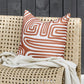 Ano outdoor cushion, rust abstract lines on the Ano on a rattan seat