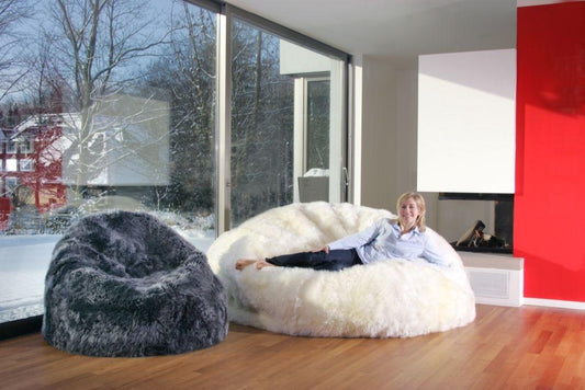 New Zealand long wool sheepskin bean bag in steel shown with oversized ivory bean bag