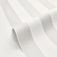White textured wallpaper with a subtle vertical stripe pattern, shown in a close-up folded view.