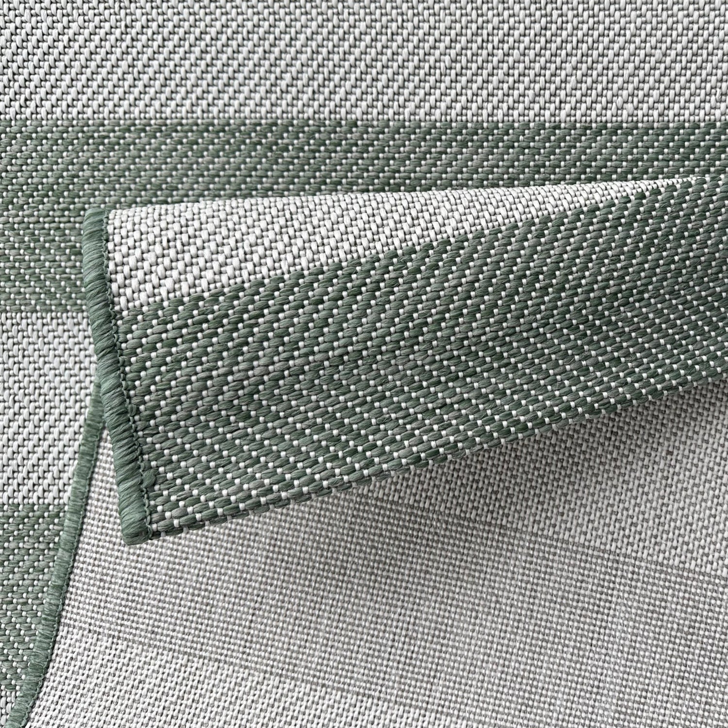 Close-up of green woven fabric with a textured pattern