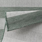 Close-up of green woven fabric with a textured pattern