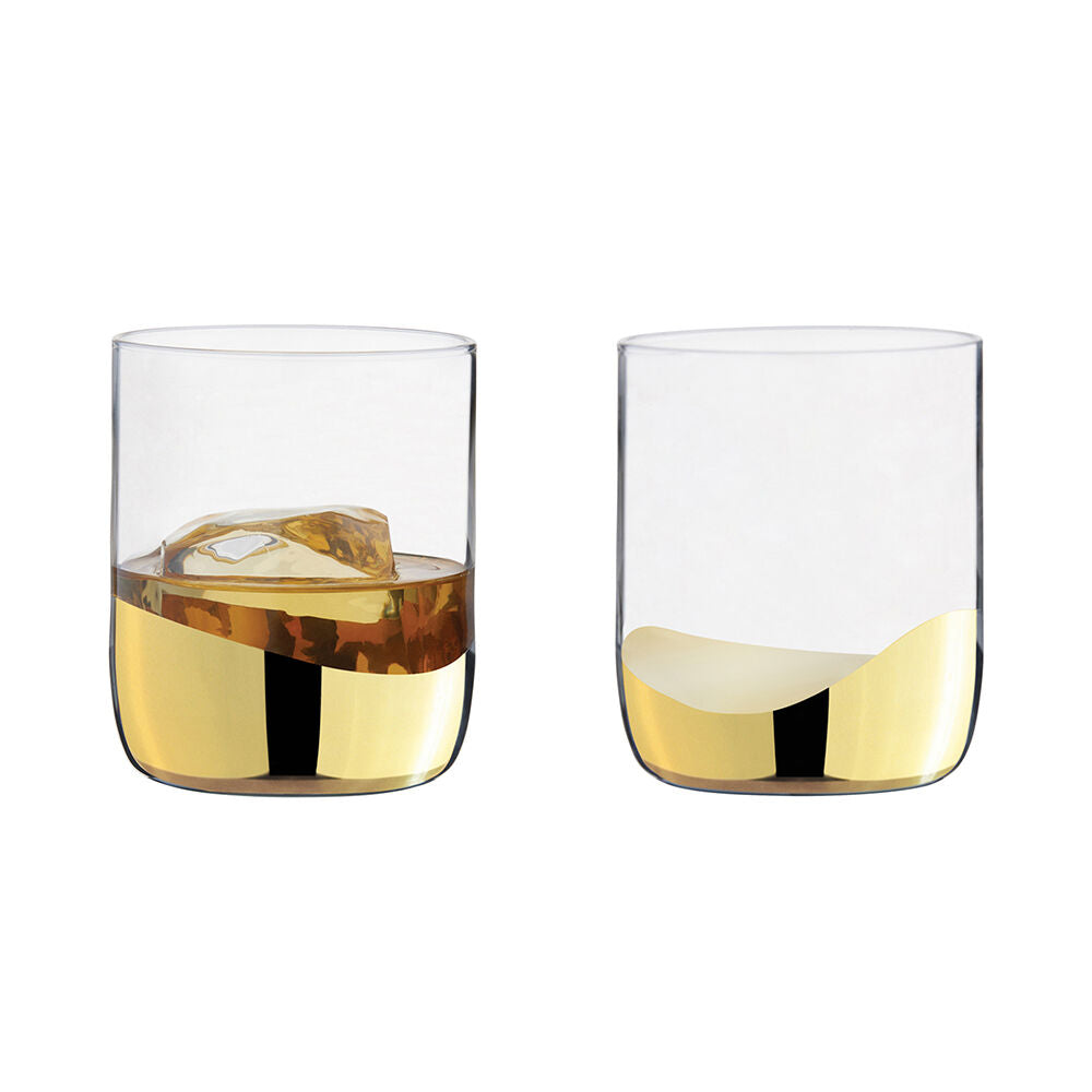 Two clear glasses with gold liquid and ice cubes on a white background