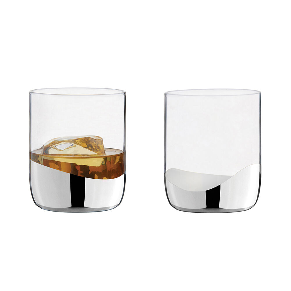 Two clear glasses with silver design, ice cubes and liquid on a white background
