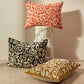 3 embroidered Aimee cushions in orange, ochre and black