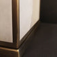 Close-up of a piece of table lamp with a brass frame and reflective surface.