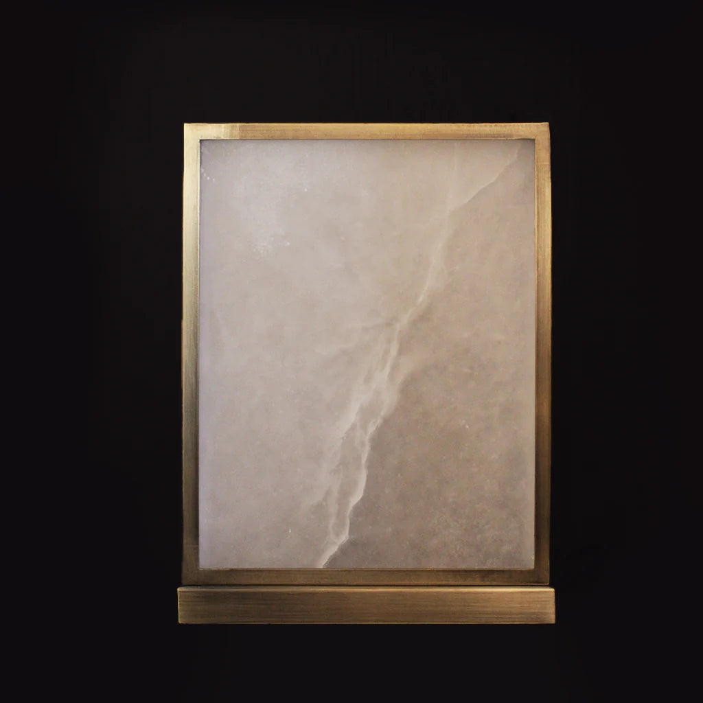 Decorative stone panel with a gold frame on a black background