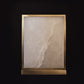 Decorative stone panel with a gold frame on a black background