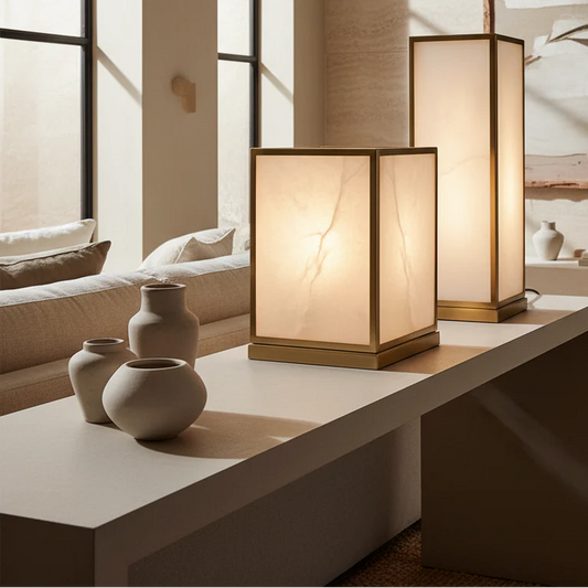 Two table lamps on a surface with decorative vases in a room setting.