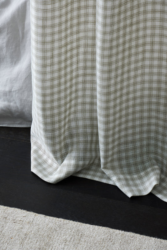 Close-up of a green plaid fabric draped over a surface