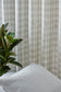 Textured wall with a plant and white pillow in the foreground