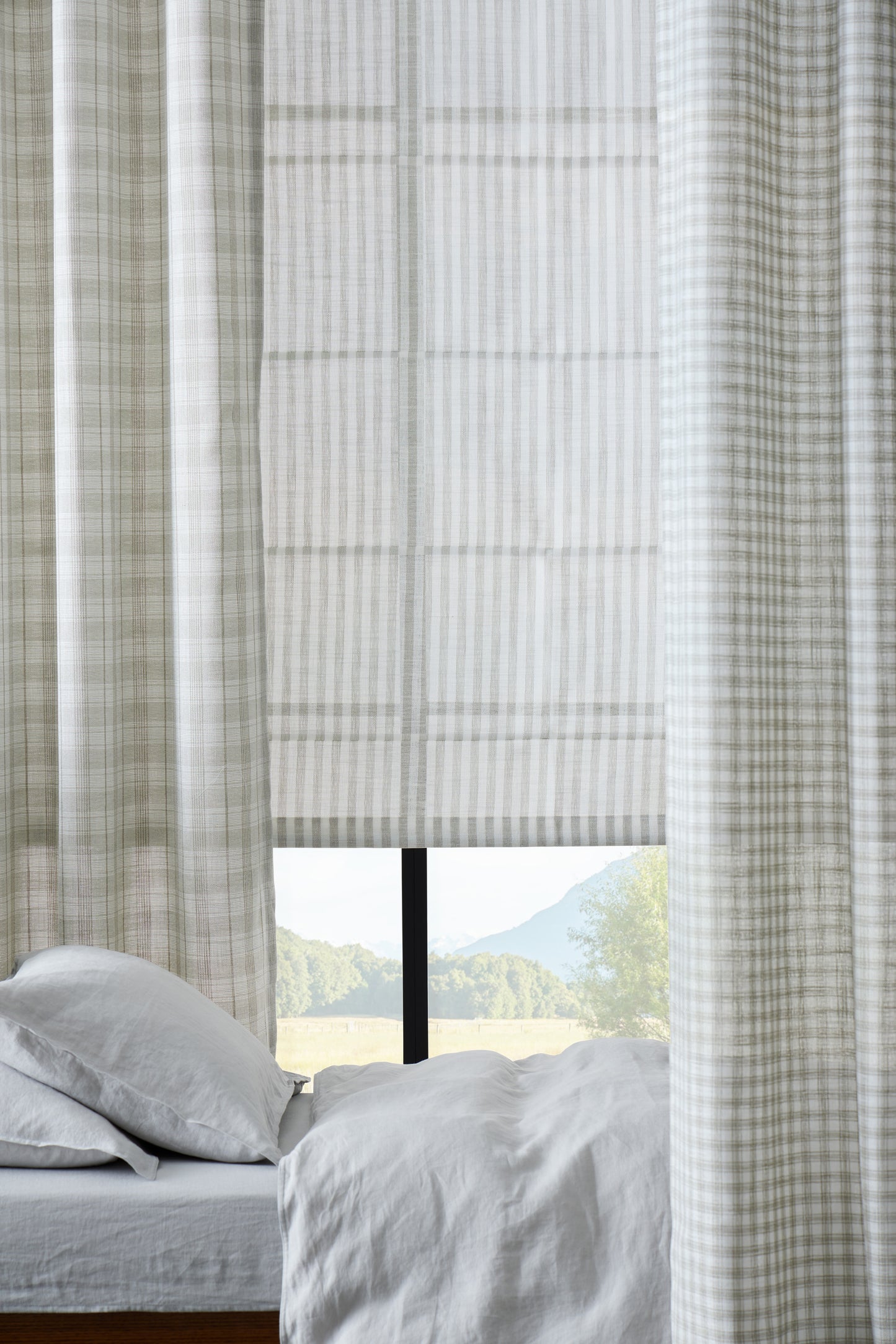 Textured window curtain with a view of a scenic landscape outside