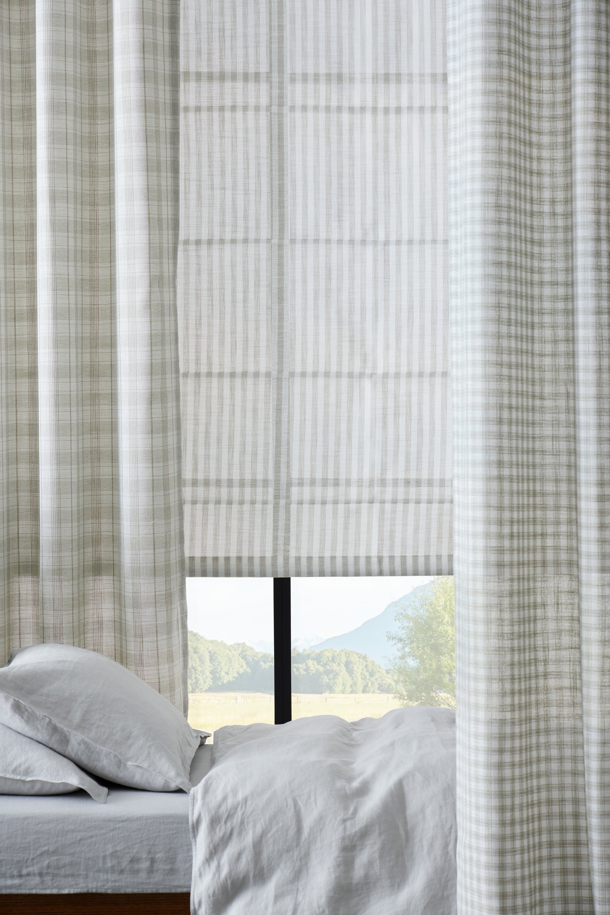 Textured window curtain with a view of a scenic landscape outside