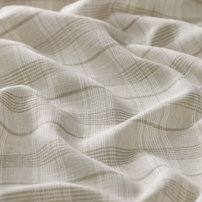 Close-up of textured beige fabric with wavy pattern