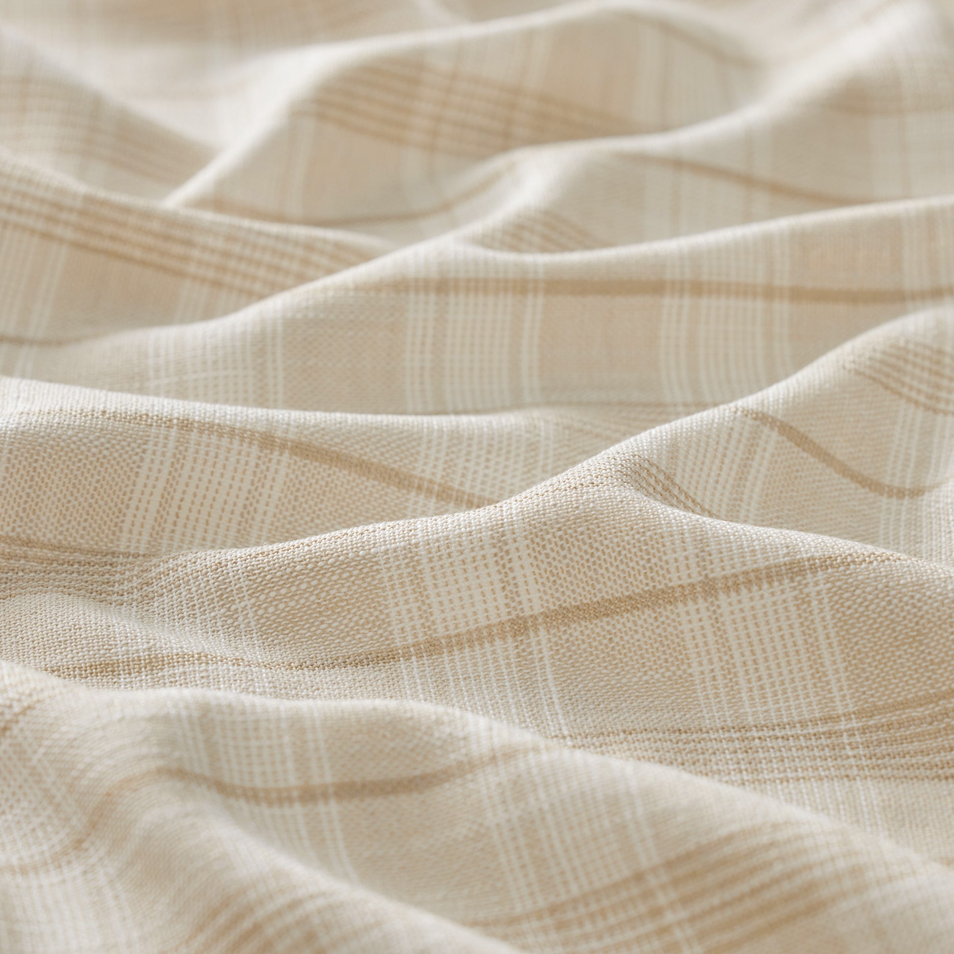 Close-up of beige fabric with subtle pattern