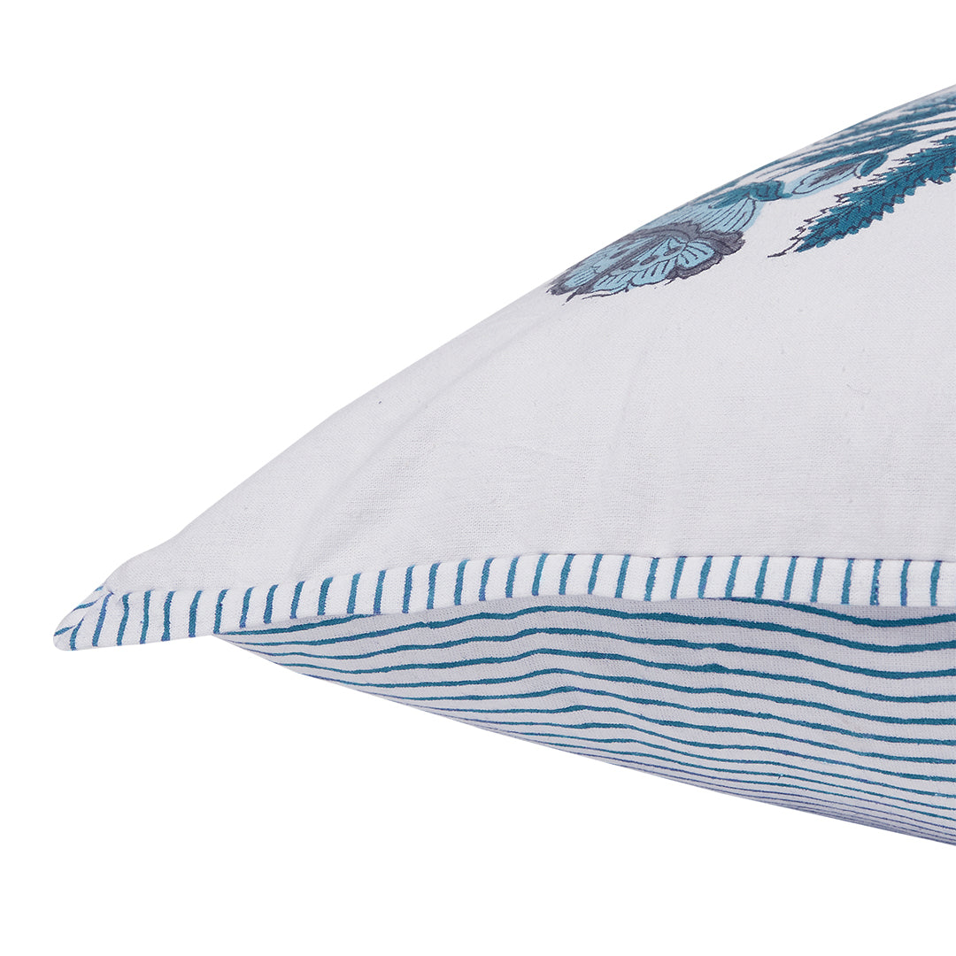 White pillow with blue decorative elements on a white background